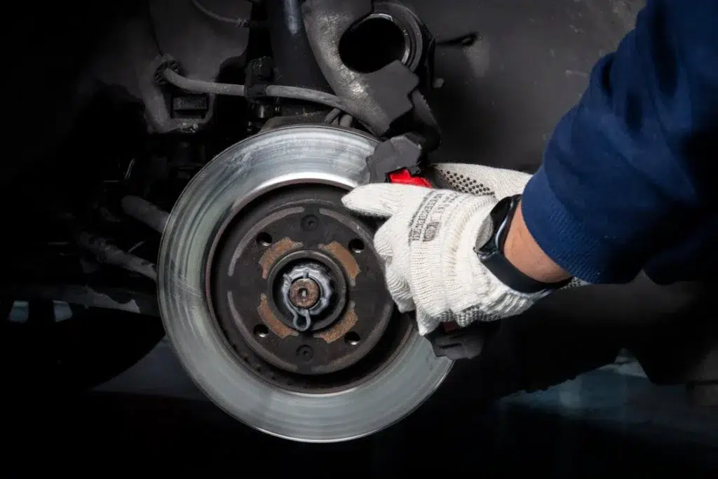 Brake repair Boca Raton – mechanic replacing brake pads at Discount Auto Repair Boca
